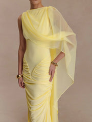 Yellow saree with a draped blouse on a plain background