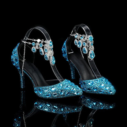 Pair of high-heeled shoes with blue gemstone embellishments on a black background