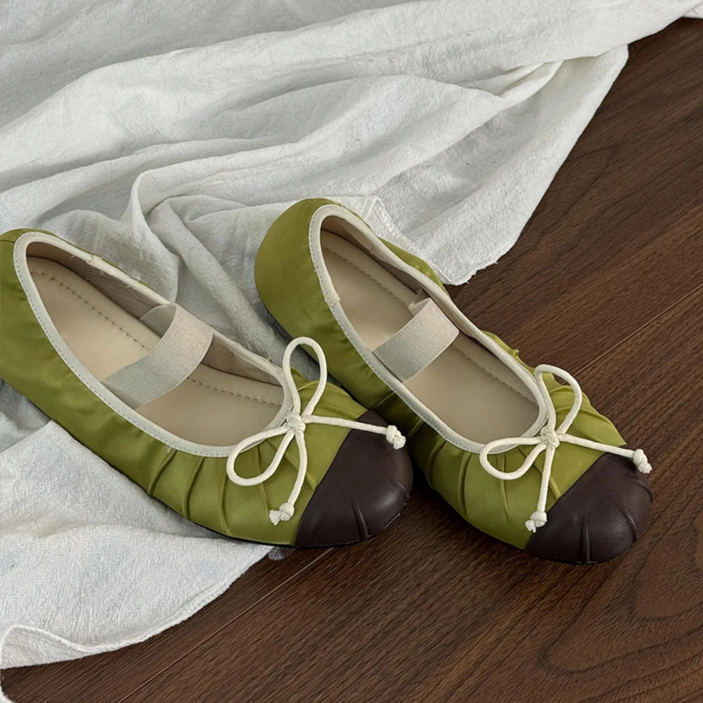 Green satin ballet flats with brown toe cap and white elastic strap
