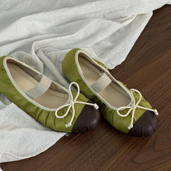 Green satin ballet flats with brown toe cap and white elastic strap