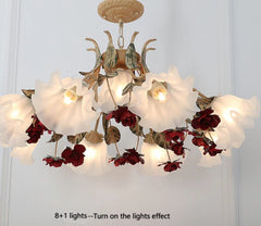 Decorative chandelier with floral design on a white wall.