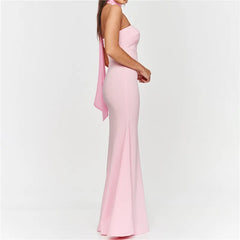 Pink strapless gown with a slit on a light gray background