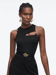 Woman wearing a black top with gold accents on a white background
