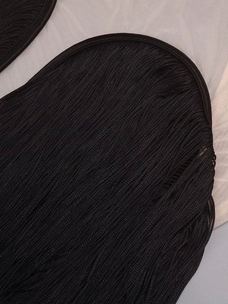 Close-up of a black textured fabric item on a light gray background