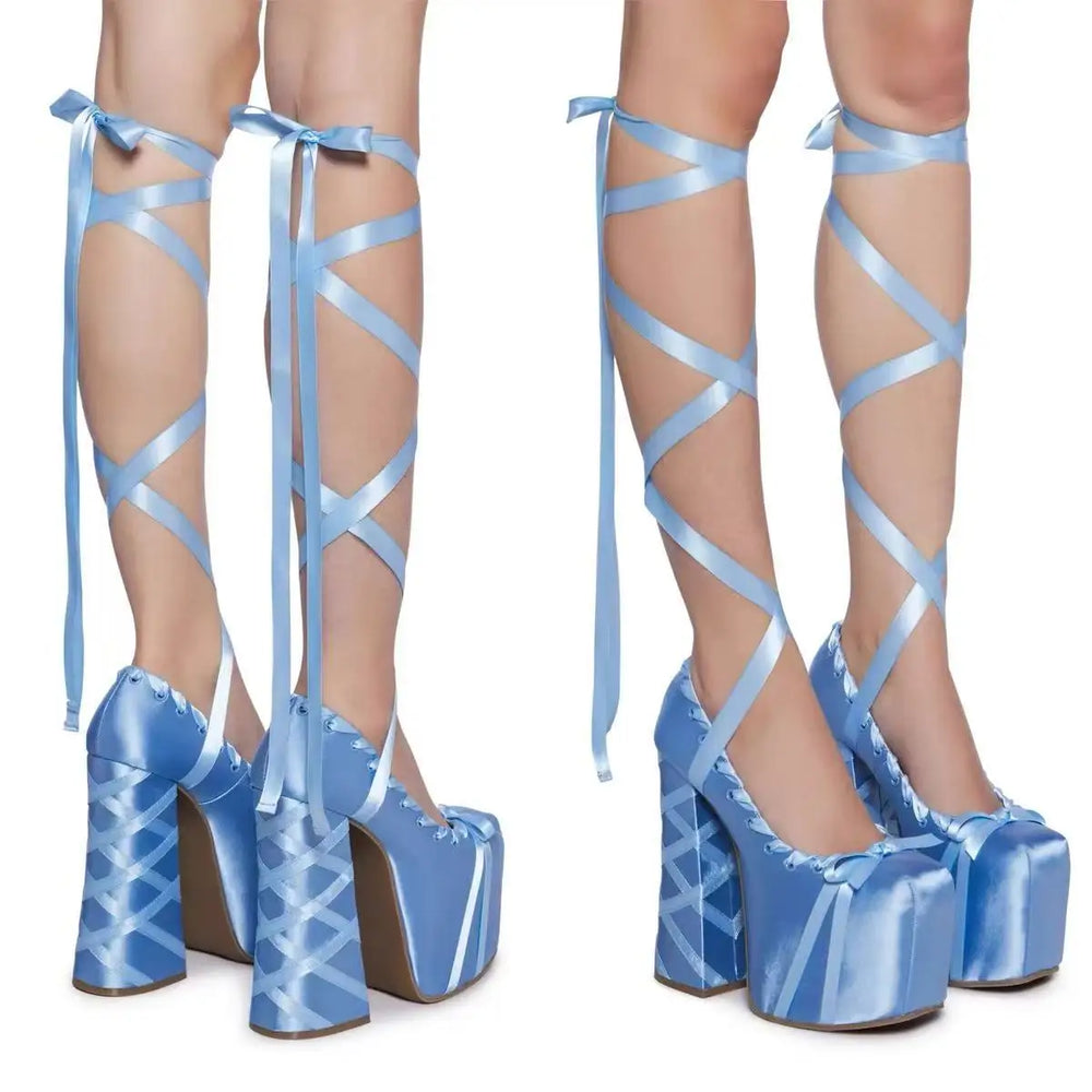 Blue strappy high-heeled shoes on a white background