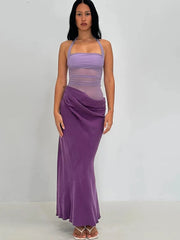 Woman wearing a purple dress against a white background