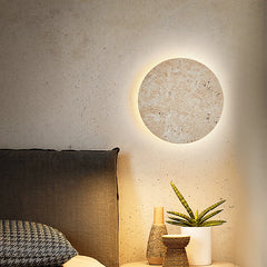   Natural yellow cave stone LED sconce with a warm glow, mounted on a bedroom wall. Golden Atelier 3