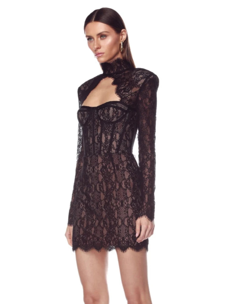 Black lace dress worn by a model on a white background