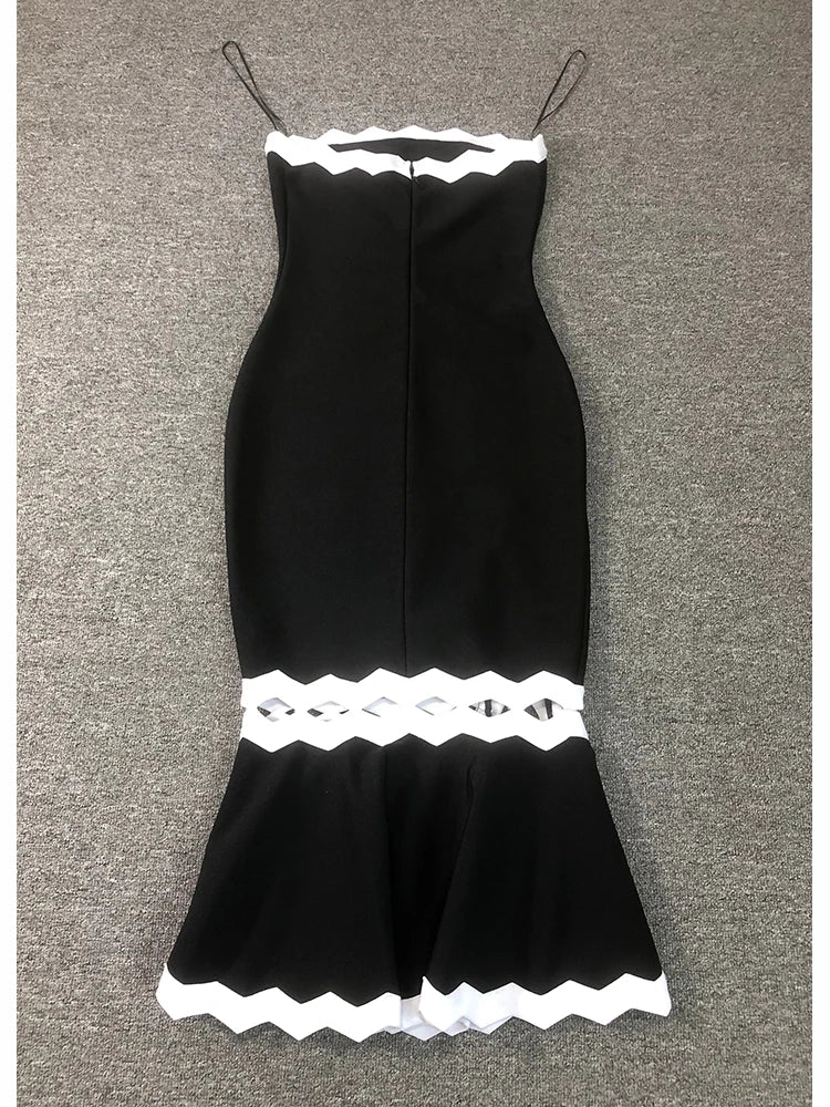 Black dress with white lace details on a gray background