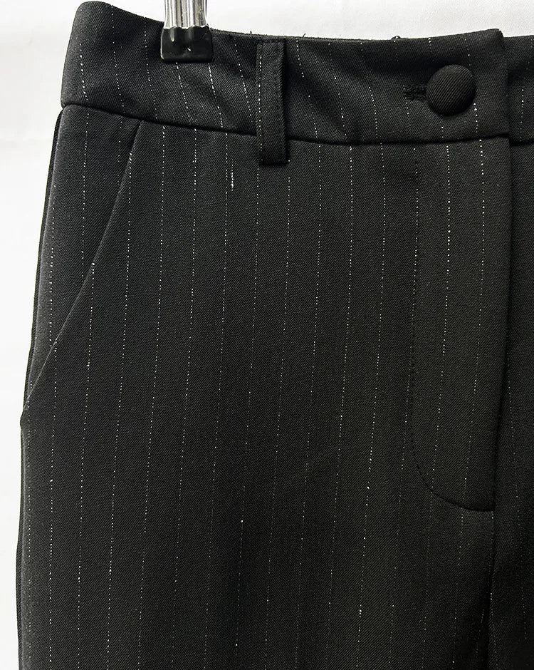 Black pinstripe pants with a button on a white background