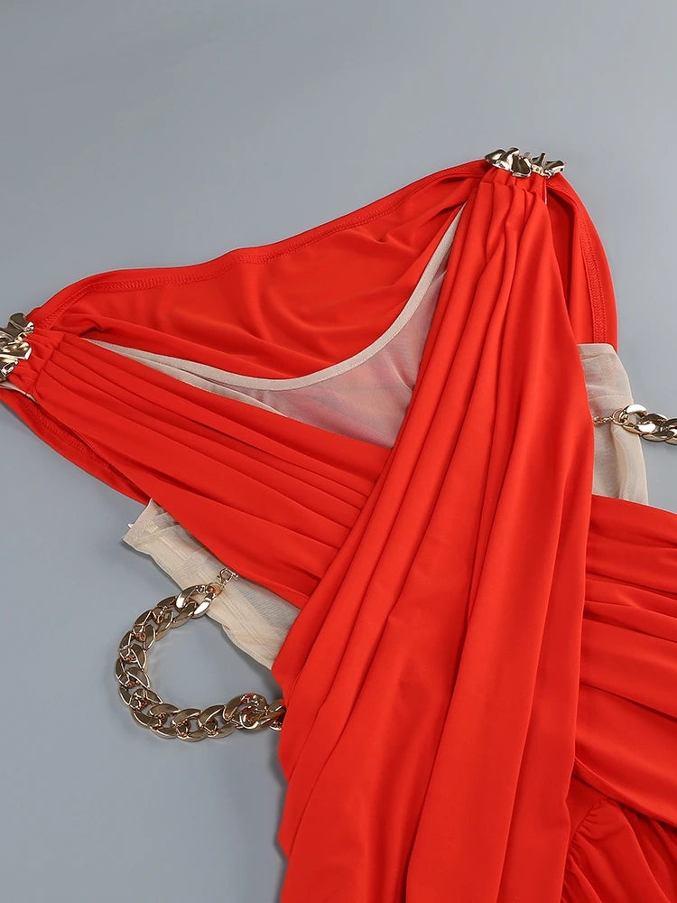 Red fabric with gold chains on a gray background
