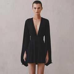 Black dress with long sleeves on a plain background