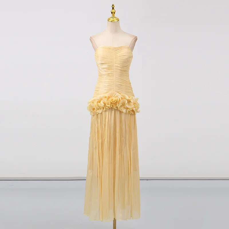 Yellow dress on a mannequin against a white background