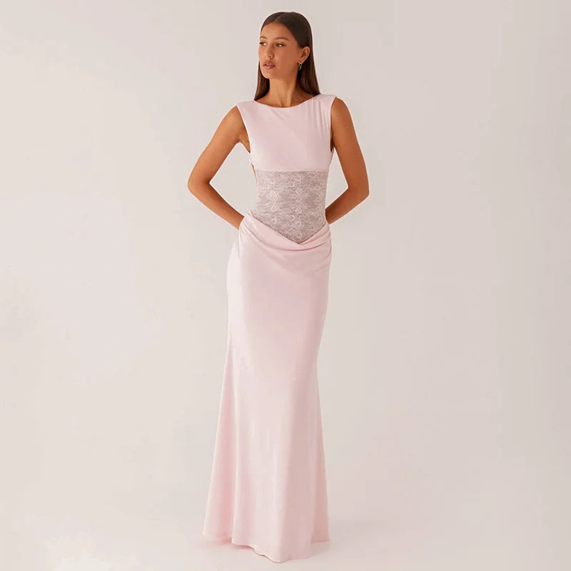 Woman wearing a pink evening gown with a silver sequin panel on a white background