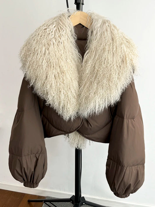 Brown cropped puffer jacket with a large curly textured fur collar and full sleeves.