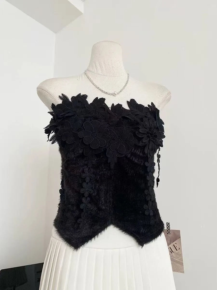 Black floral top on a mannequin against a white background