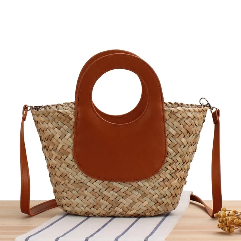Woven handbag with brown leather patch on a white background