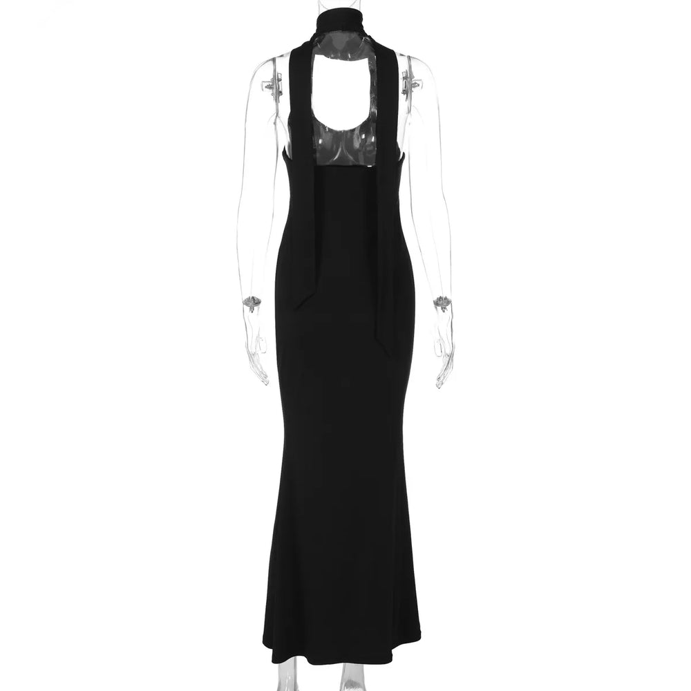 Black evening gown with cut-out back on a mannequin against a white background