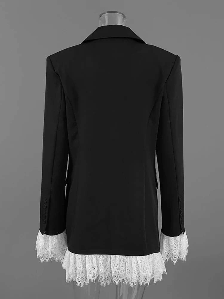Black blazer with white lace trim on a gray background