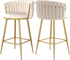 Two beige bar stools with gold legs on a white background