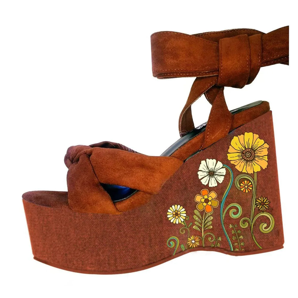 Brown wedge sandal with floral design on a white background