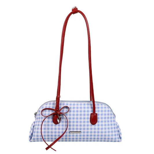 Blue and white gingham pattern shoulder bag with red patent handles and a red bow detail.