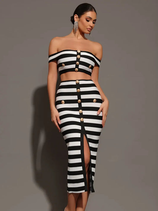 Woman wearing a black and white striped outfit with button details on a gray background