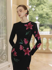 Close-up of black long sleeve gown with floral beading