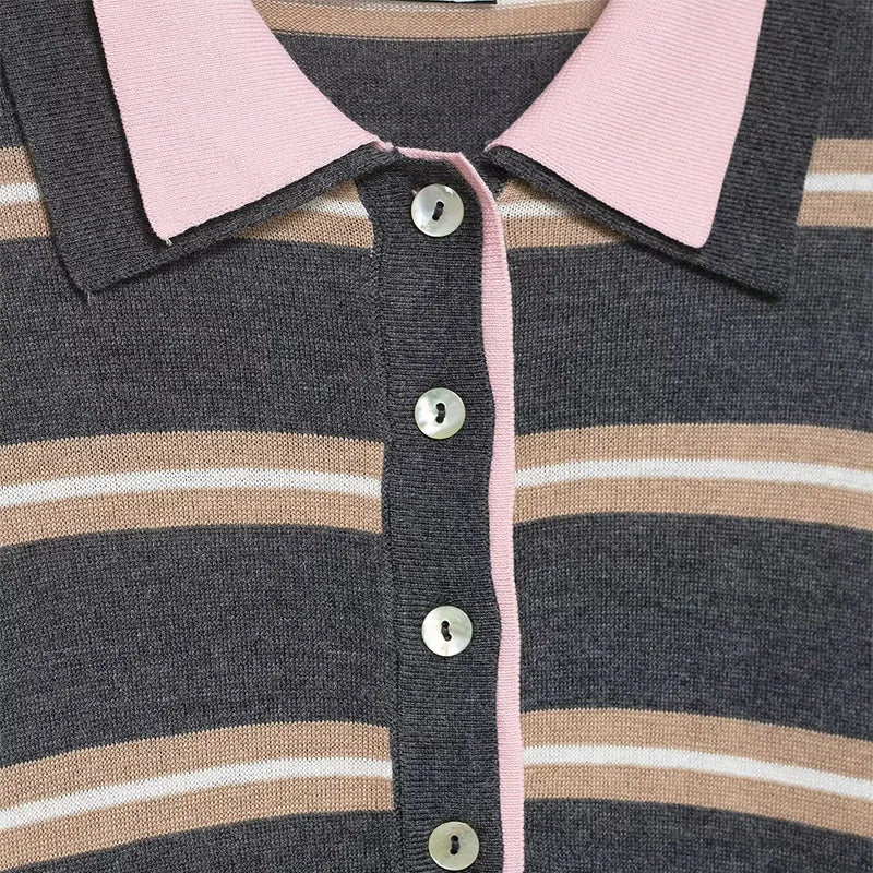 Close-up of a striped shirt with pink collar and buttons.