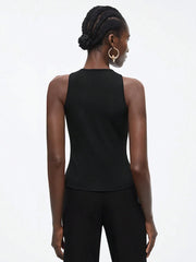 Person wearing a black sleeveless top and pants on a white background