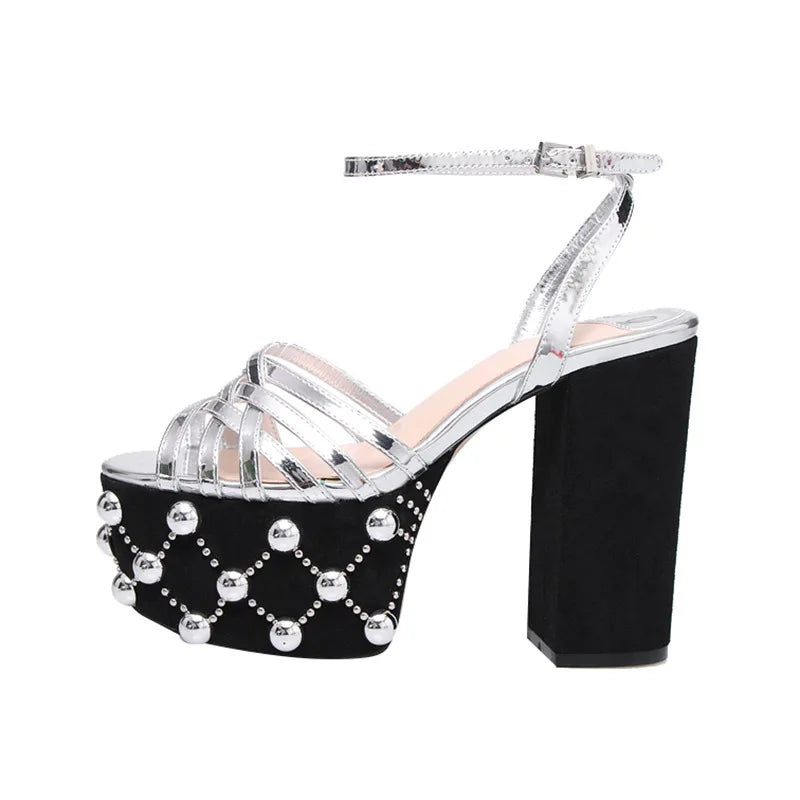 Silver metallic platform sandals with a black suede platform and decorative studs.