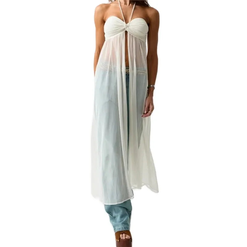 Woman wearing a white halter top and light blue pants on a white background
