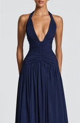 Navy blue halter neck gown on a plain background
