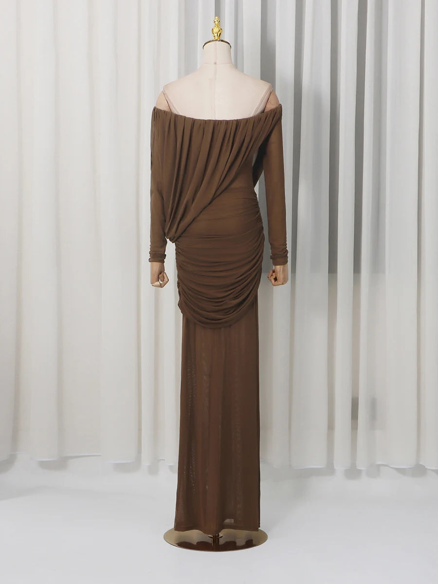 Brown off-shoulder evening gown on a mannequin against a white curtain background