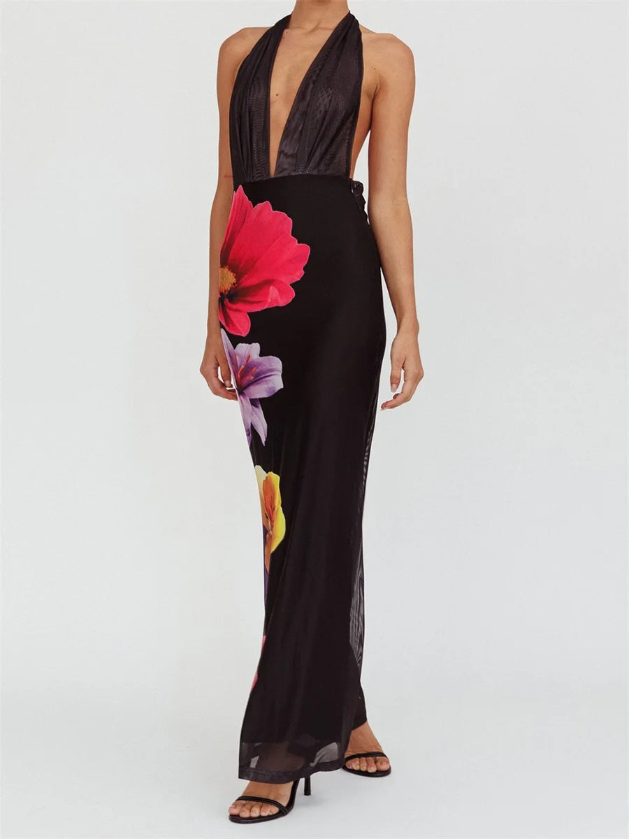 Black halter neck dress with floral design on a white background