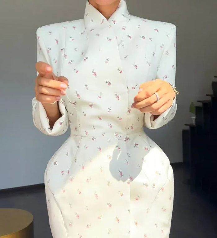 Person wearing a light blue floral dress with a blurred background
