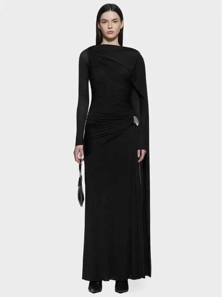 Woman wearing a black dress with long sleeves on a white background