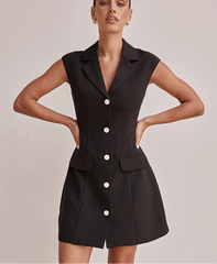 Black sleeveless blazer dress with white buttons on a plain background