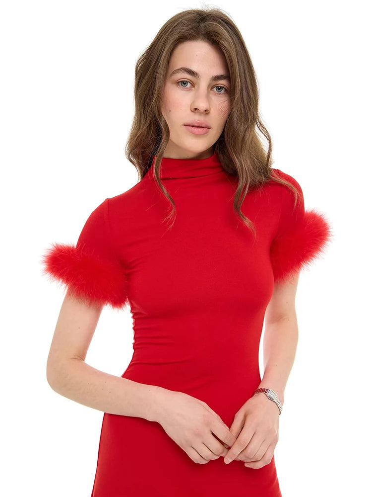 Woman wearing a red dress with fluffy sleeves on a white background
