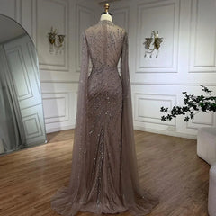 Mannequin  displaying  the beaded lace mermaid gown with cape sleeves, showcasing its elegant silhouette and train. Golden Atelier 3