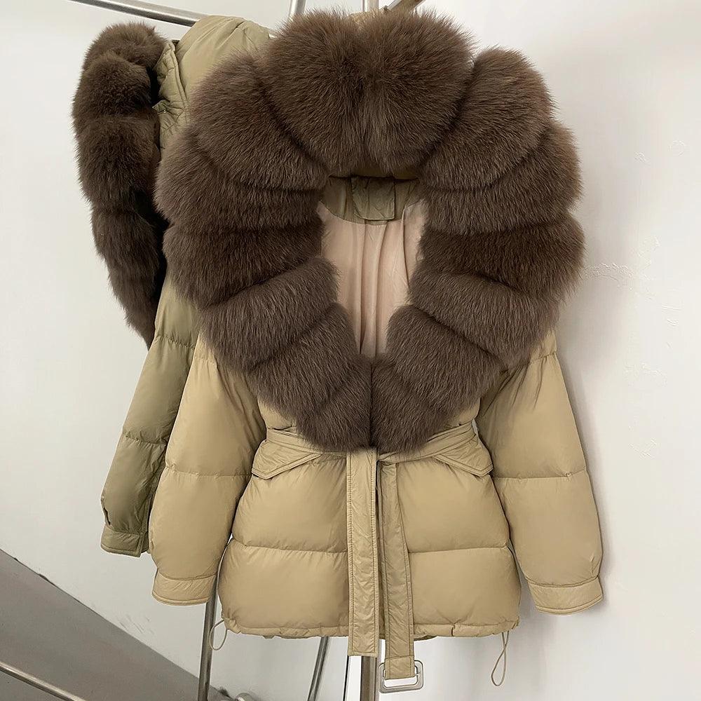 Beige puffer jacket with large brown fur collar on a stand