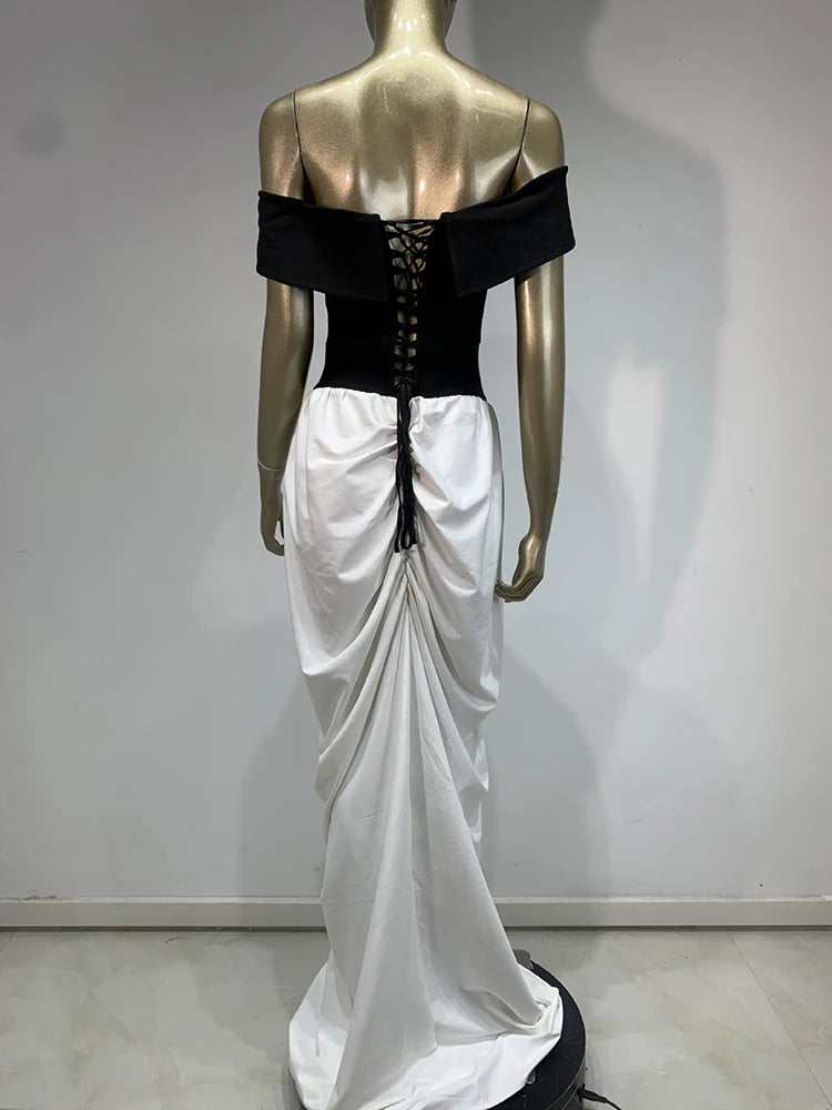 Mannequin wearing a black and white dress with a corset-style top against a plain background
