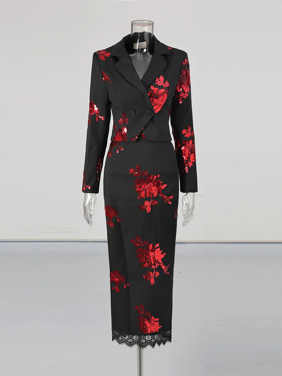Black dress with red floral patterns on a mannequin against a white background