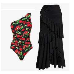 One-piece swimsuit with cherry print and ruffled detailing, alongside a black ruffled midi skirt.