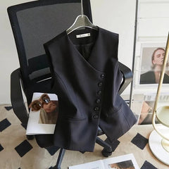 Black vest on a chair with fashion magazines underneath