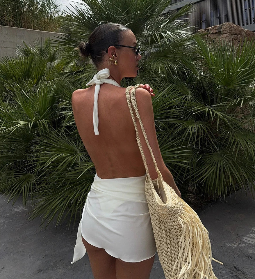 Back view of textured one-piece swimsuit and wrap skirt