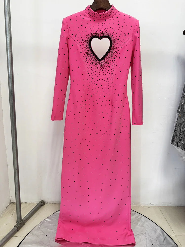 Front of pink long-sleeved maxi dress with heart detail and embellishments