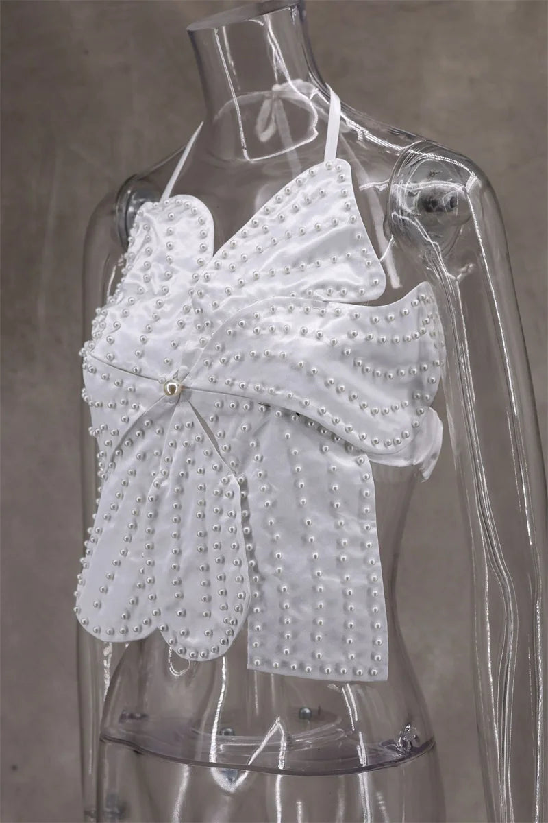 White lace top on a transparent mannequin against a gray background