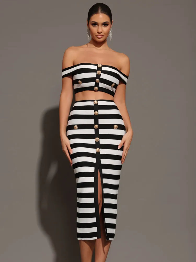 Woman wearing a black and white striped outfit with button details on a gray background