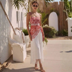 Woman wearing the floral print swimsuit and fringed sarong.